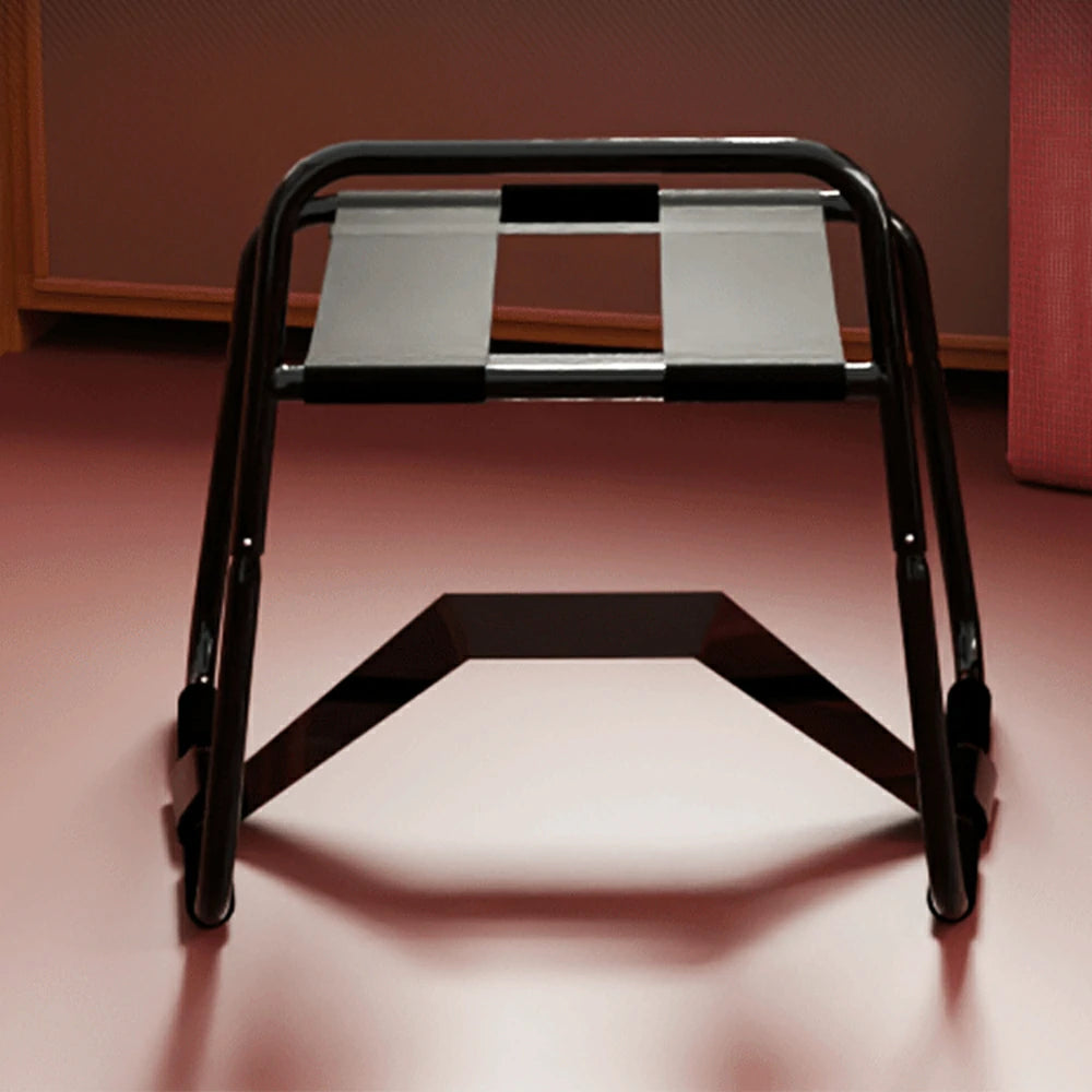 Black elastic sex chair with dual straps and square armrests.
