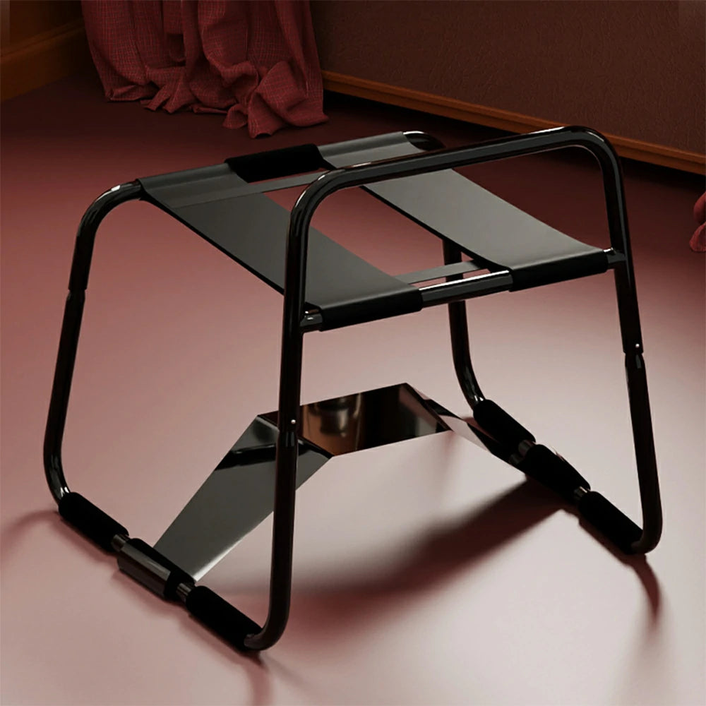 Black elastic sex chair with dual straps and square armrests.