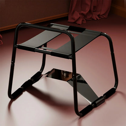Black elastic sex chair with dual straps and square armrests.