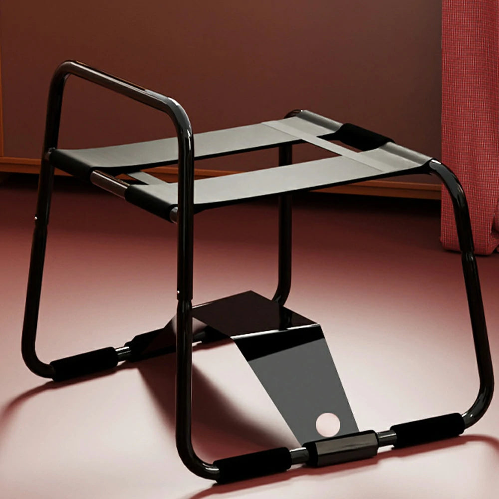 Black elastic sex chair with dual straps and square armrests.